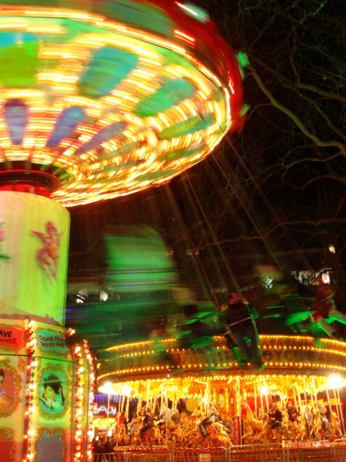 People being swung around on the 'swinging-chair-ride', London (2006)