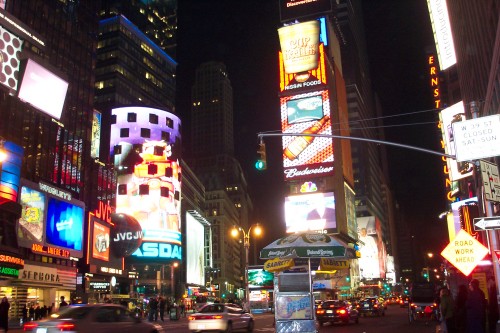 A hot dog vendor selling at Times Square at night, New York (2006)
