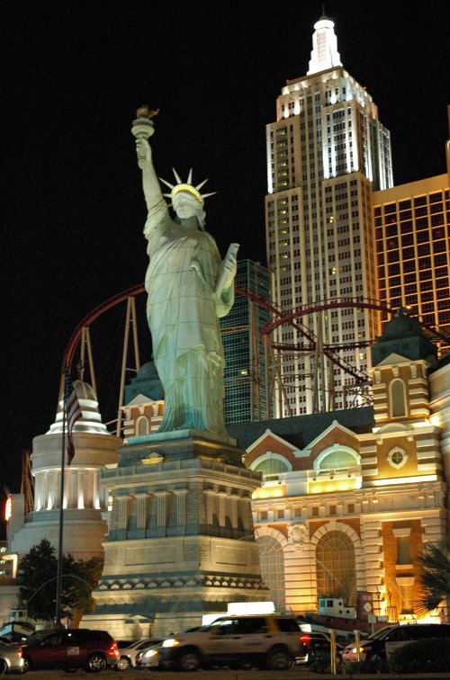 Replica Statue of Liberty with the famous rollercoaster on top of the casino in the background. Las Vegas (2007)