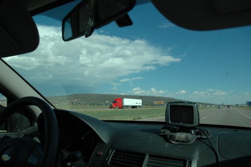 Driving along a freeway in New Mexico Lots of big old trucks. The stupid Sat-Nav which took us down a desert track still looks a little dirty. New Mexico (2007)